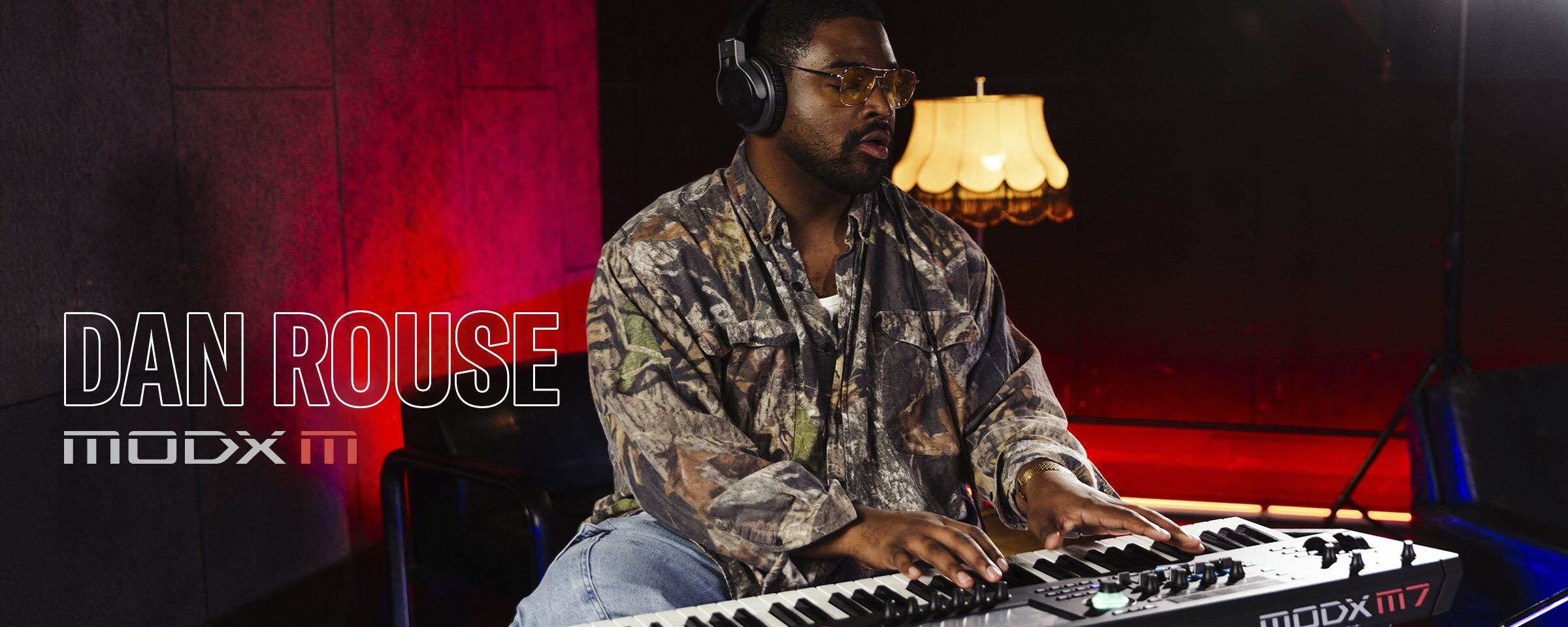 Visual of Dan Rouse playing a synthesizer in a performance scene