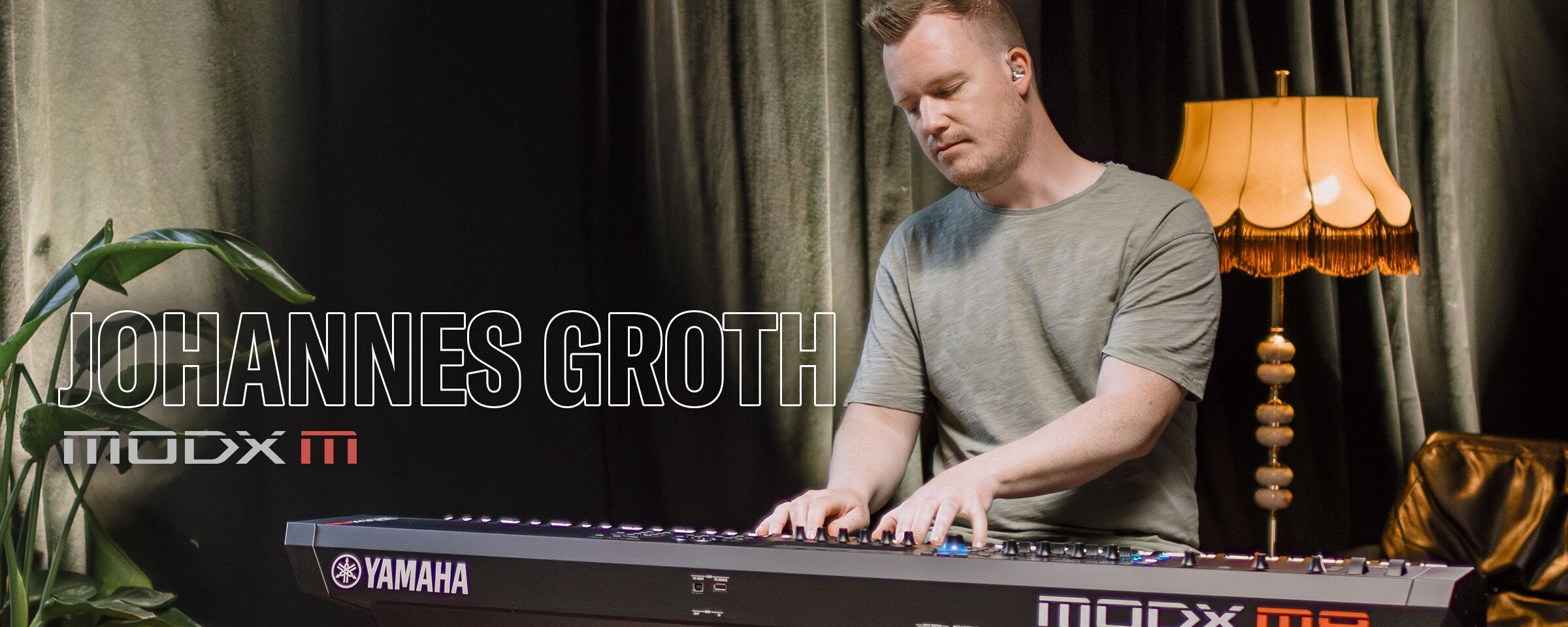 Visual of Johannes Groth playing a synthesizer in a performance scene