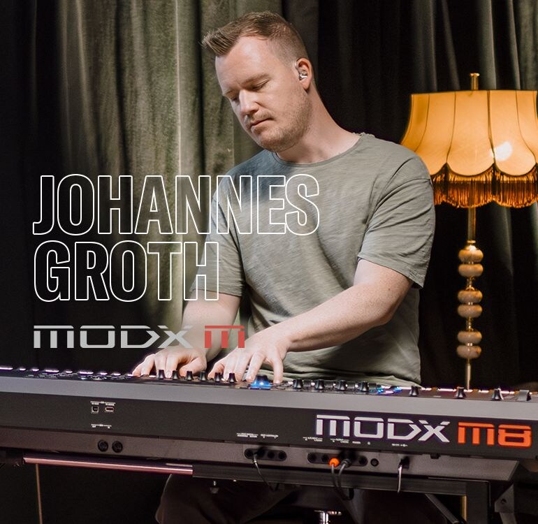 Visual of Johannes Groth playing a synthesizer in a performance scene