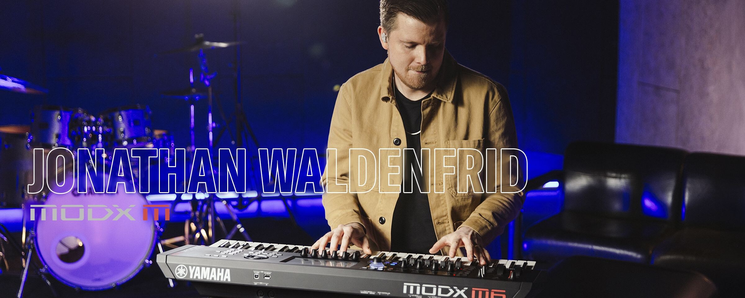 Visual of Jonathan Waldenfrid playing a synthesizer in a performance scene