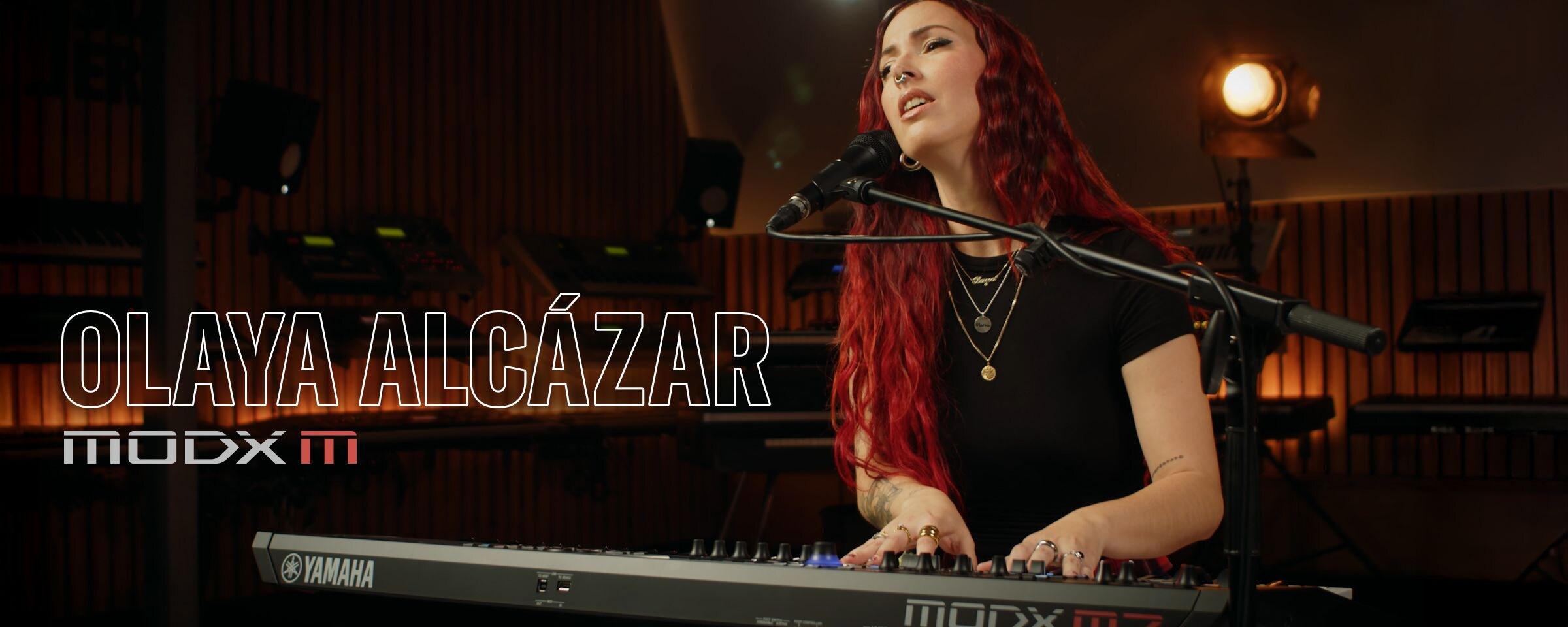 Visual of Olaya Alcázar playing a synthesizer in a performance scene